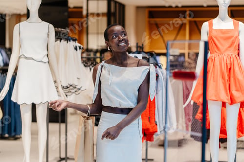 Preview: African American Woman Navigating Through Modern Clothing Store