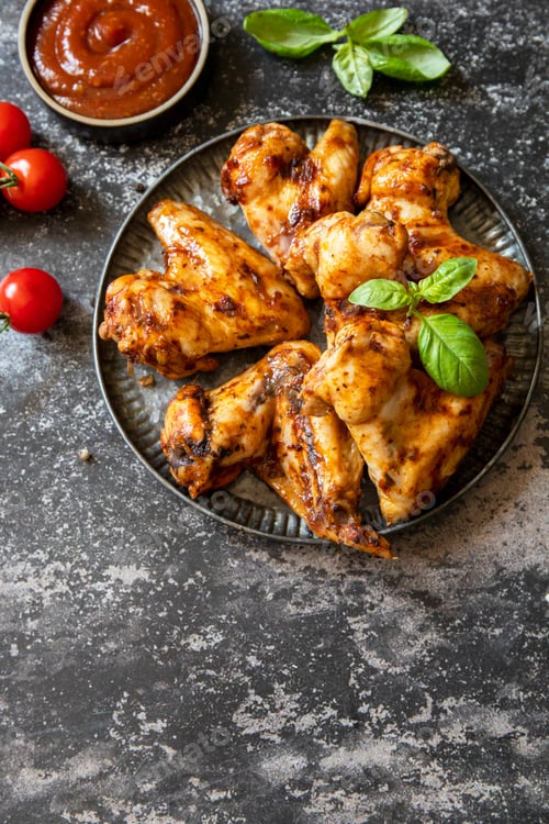 Preview: Barbecue chicken wings with sauce on a stone surface. Traditional baked bbq buffalo. Tasty snack for