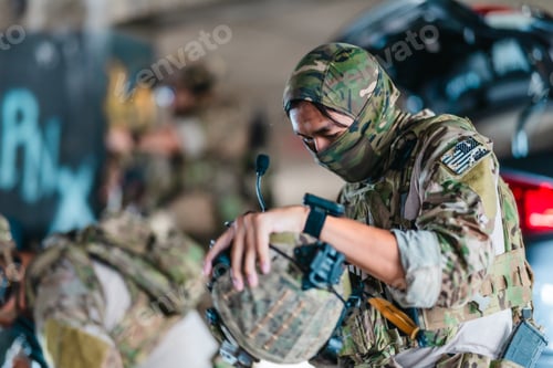 Preview: Tactical operator prepares and adjusts ballistic helmet and combat gear before mission deployment