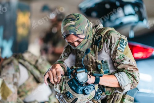 Preview: Tactical operator prepares and adjusts ballistic helmet and combat gear before mission deployment