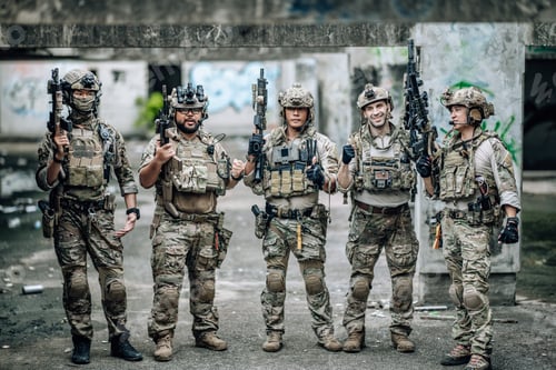 Preview: Tactical team celebrates mission success raising helmets and fists together in abandoned building