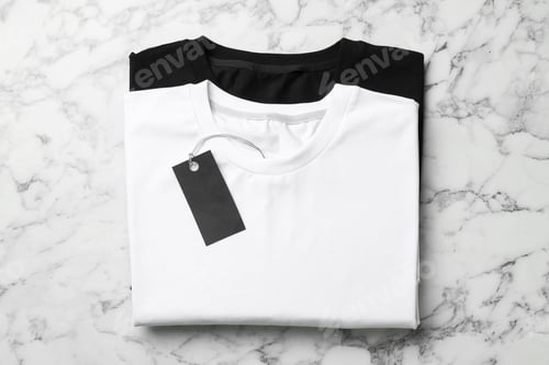 Preview: Blank folded t-shirts on white marble background, top view. Mockup for design