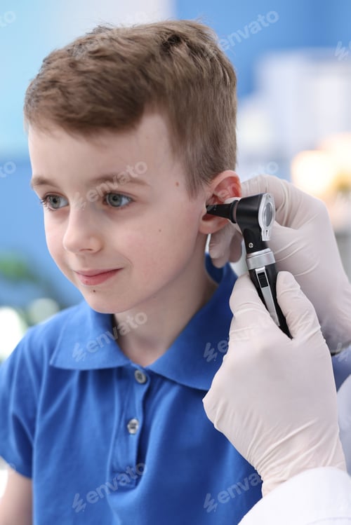 Preview: Hearing test. Doctor examining boy's ear with otoscope in clinic, closeup