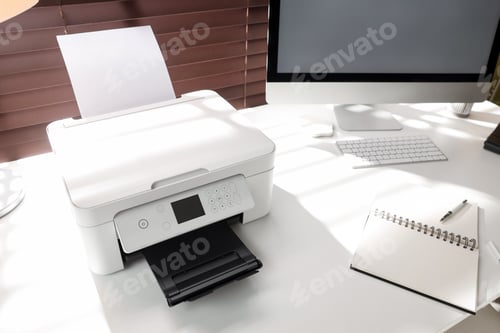 Preview: Modern printer, computer and stationery on white table in office, closeup