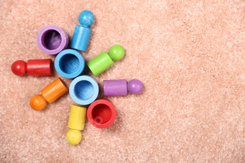 Preview: Bright sorting set with colorful figures on pink carpet, top view. Space for text