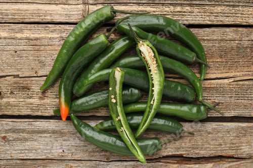 Preview: Fresh green chili peppers on wooden table, top view