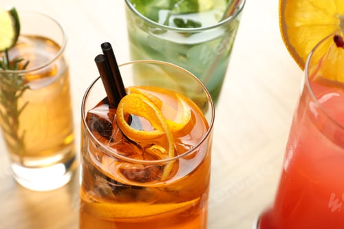 Preview: Different tasty refreshing cocktails in glasses on table, closeup