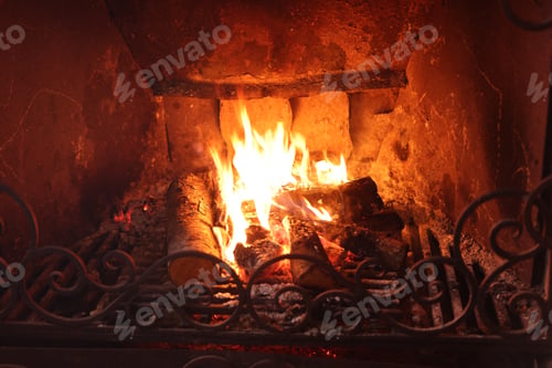 Preview: Wood burning in fireplace at home, closeup