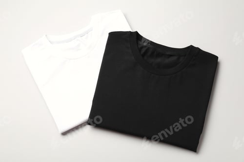 Preview: Blank folded t-shirts on light grey background, top view. Mockup for design