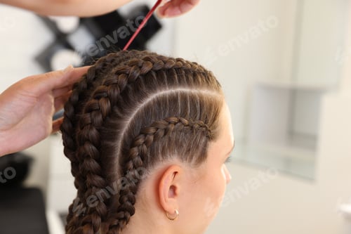 Preview: Hair braiding. Hairdresser working with teenage girl in salon, closeup