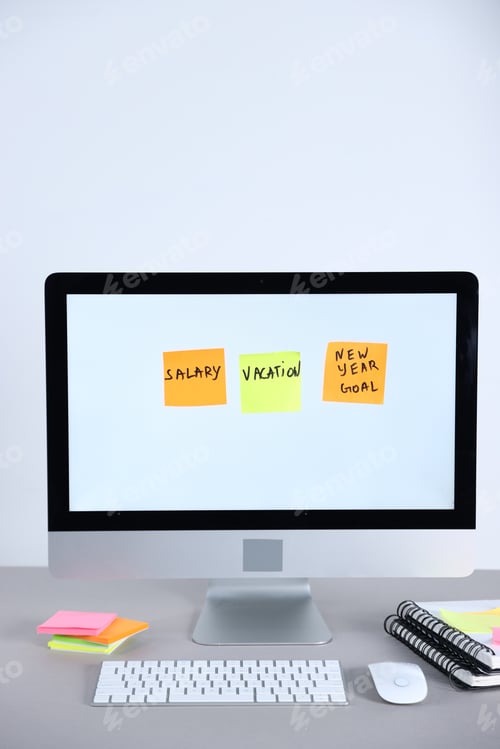Preview: Computer with colorful reminders on grey table against white background. Planning and deadline