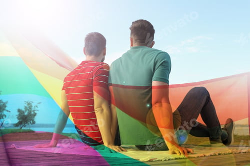Preview: Gay couple sitting near river, double exposure with pride flag