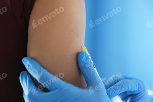Preview: Nurse with syringe vaccinating man in hospital, closeup. Space for text