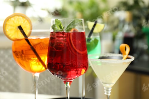 Preview: Different tasty refreshing cocktails in glasses indoors, closeup