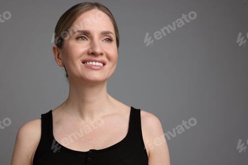 Preview: Portrait of beautiful woman on grey background, space for text