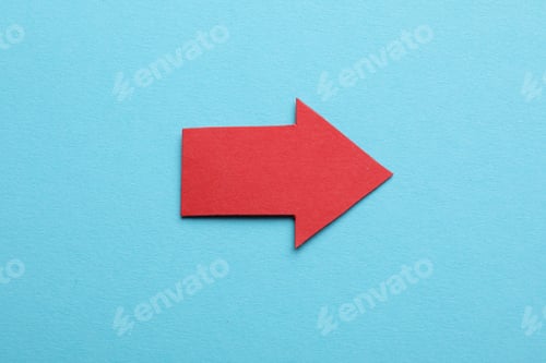 Preview: Red paper arrow on light blue background, top view
