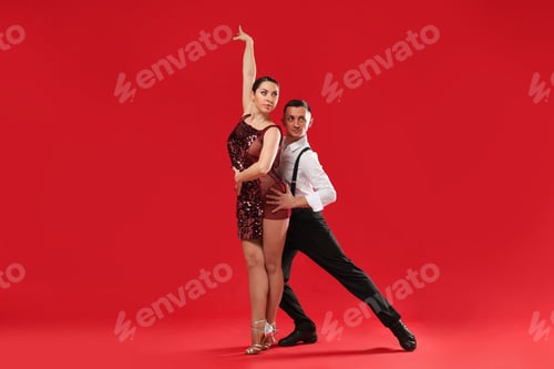 Preview: Couple of professional dancers on red background
