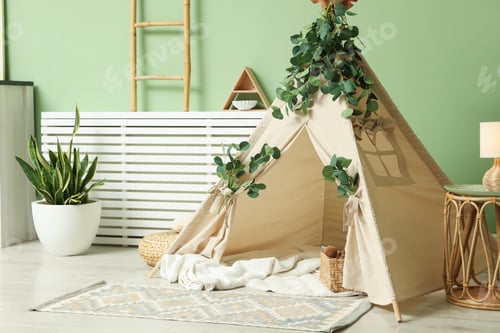 Preview: Cute wigwam with leaves and blanket in stylish child's room