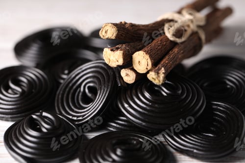Preview: Natural licorice candies and roots on table, closeup