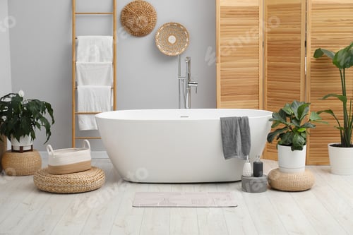 Preview: Stylish bathroom mat with pattern near bathtub on floor indoors. Interior design