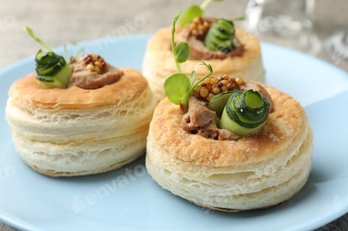 Preview: Tasty puff pastries with pate, cucumber, microgreens and whole grain mustard on table, closeup