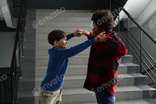 Preview: Bullying. Boy fighting with his African American classmate in school
