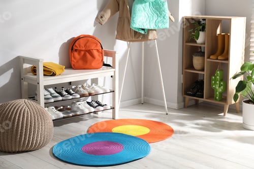 Preview: Shoe storage bench with different children's footwear, backpack, clothes and houseplants indoors