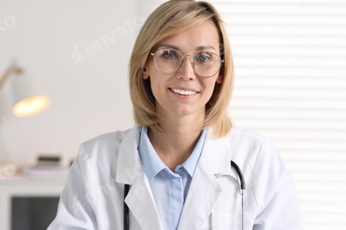 Preview: Portrait of smiling doctor on blurred background