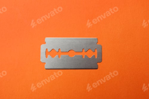 Preview: One sharp blade on red background, top view