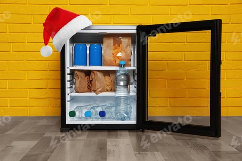 Preview: Open fridge with red Santa hat near orange brick wall in room