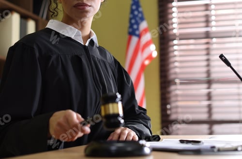 Preview: Judge striking gavel at wooden desk indoors