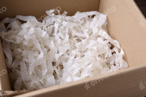 Preview: Shredded paper filling in cardboard box, closeup