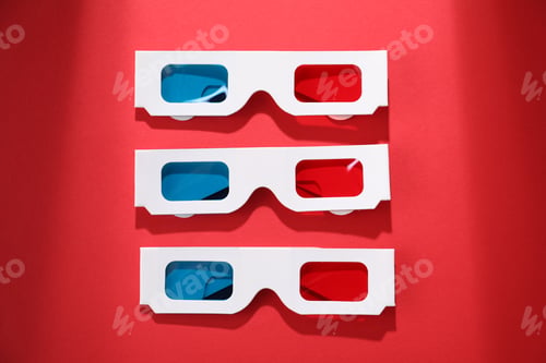 Preview: 3D glasses on red background, flat lay