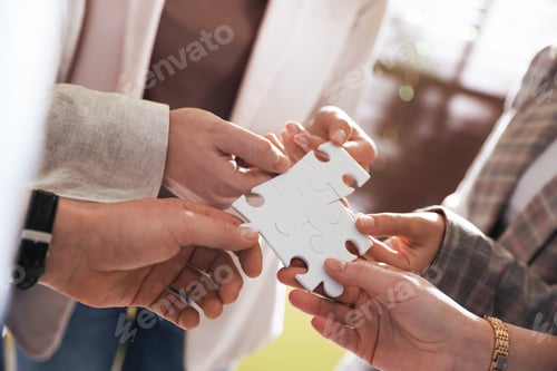 Preview: Team building. Group of businesspeople holding puzzle pieces together indoors, closeup