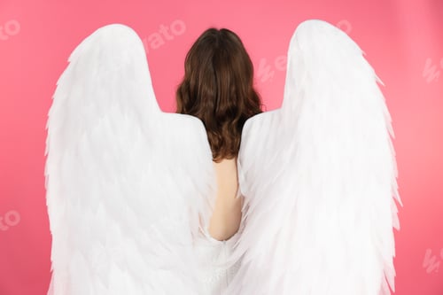 Preview: Girl with angel wings on pink background, back view