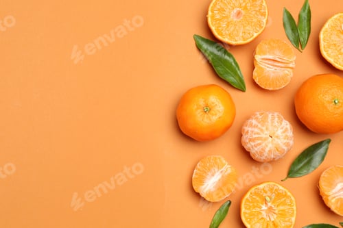 Preview: Fresh tangerines and green leaves on orange background, flat lay. Space for text