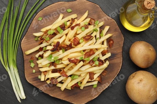 Preview: Delicious French fries with bacon and green onions served on black table, flat lay