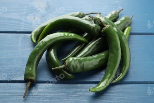 Preview: Hot green chili peppers on blue wooden table, closeup