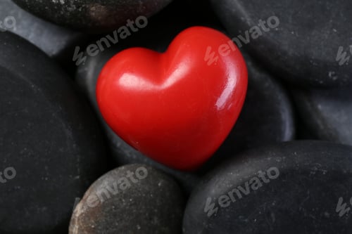 Preview: Red decorative heart on pebble stones, above view