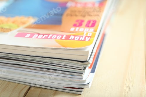 Preview: Many lifestyle magazines on wooden table, closeup. Space for text