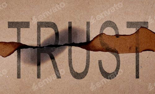 Preview: Pieces of paper with word Trust and burnt edges. Betrayal