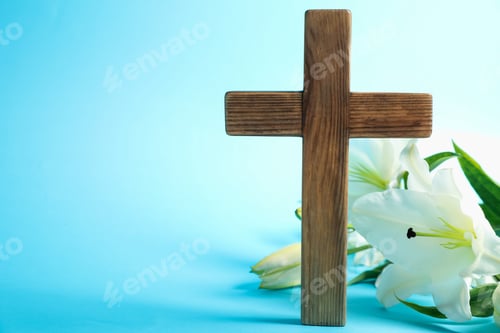 Preview: Easter. Wooden cross and beautiful lily flowers on light blue background, closeup with space for tex