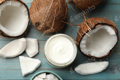 Preview: Delicious coconut yogurt in glass jar and fruits on light blue wooden table, flat lay