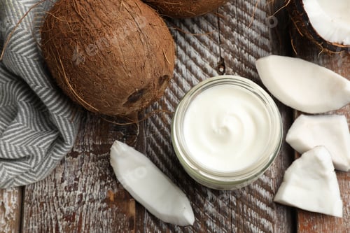 Preview: Delicious coconut yogurt in glass jar and fruits on wooden table, flat lay