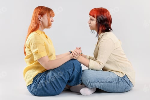 Preview: Lovely lesbian couple on gray background. LGBT concept