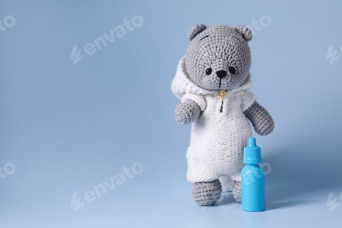 Preview: Toy bear and nasal spray on light blue background, space for text