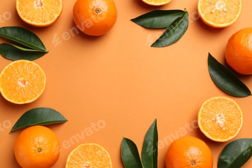 Preview: Frame made of fresh ripe tangerines and leaves on orange background, flat lay. Space for text