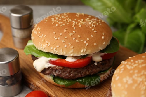Preview: Delicious burger with meat patty on table, closeup