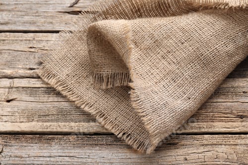 Preview: Natural burlap fabric on wooden table, closeup
