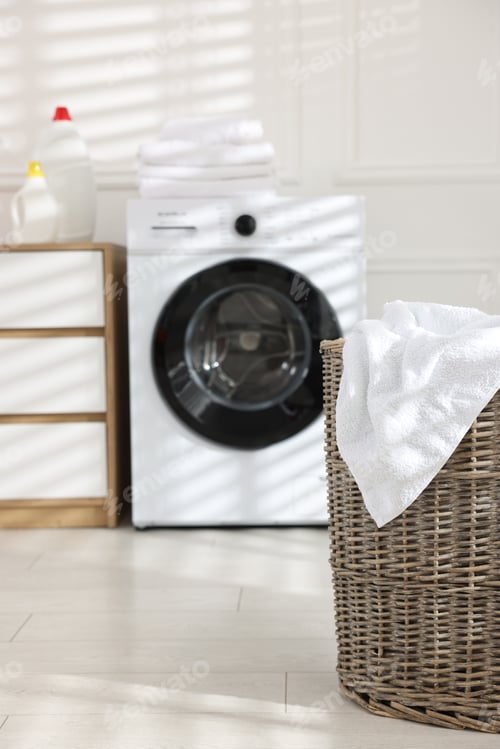 Preview: Laundry basket with dirty towel indoors, selective focus